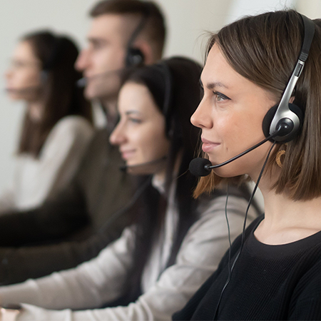 Support agent wearing a headset and smiling